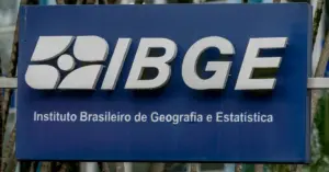 Placa do IBGE, com fundo azul e letras brancas, exibindo o nome e o logotipo da instituição / Concurso IBGE