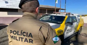 Policial Militar uniformizado em frentre a um viatura / Concurso PM PR